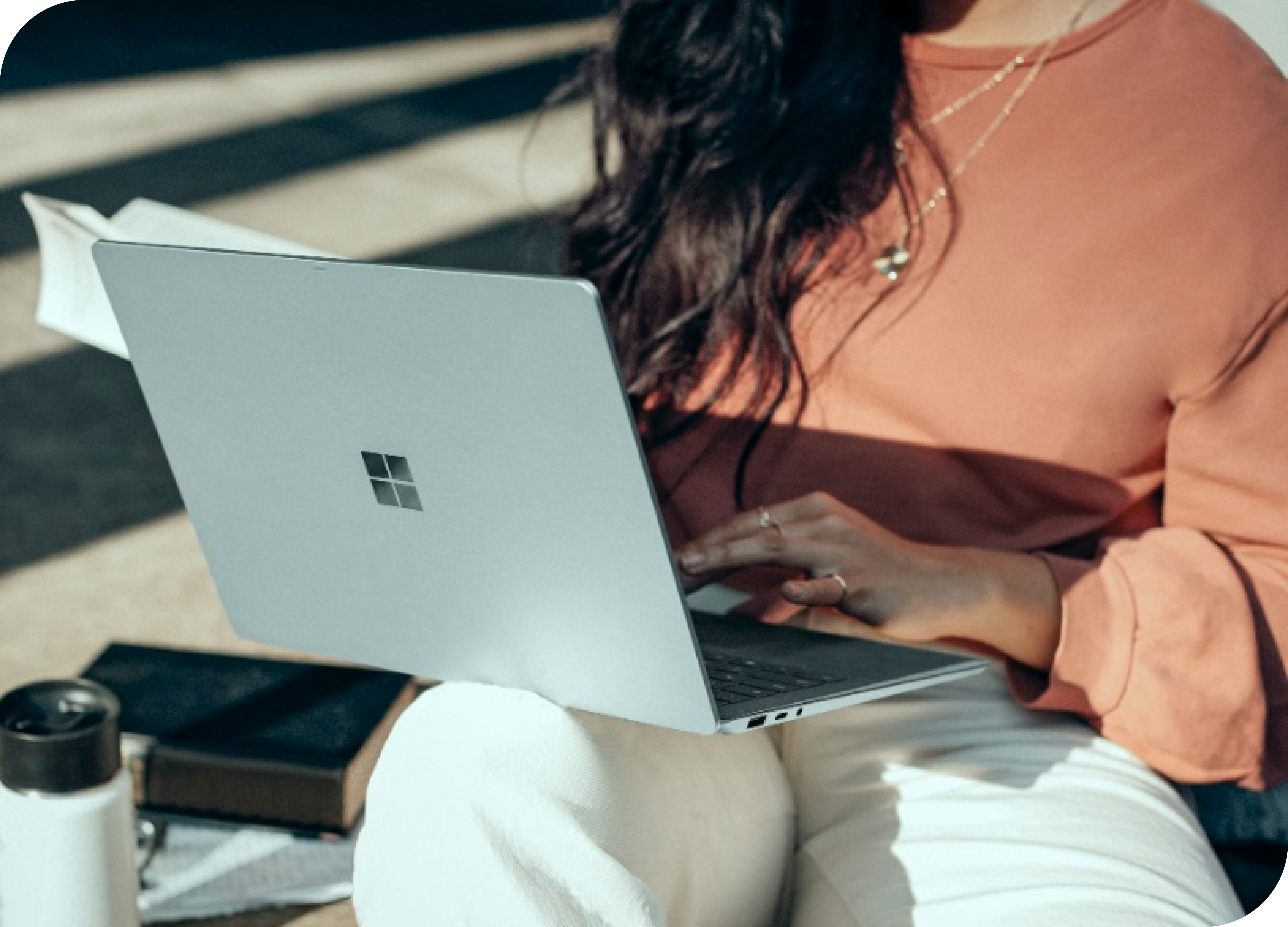 Woman using a laptop while sittng